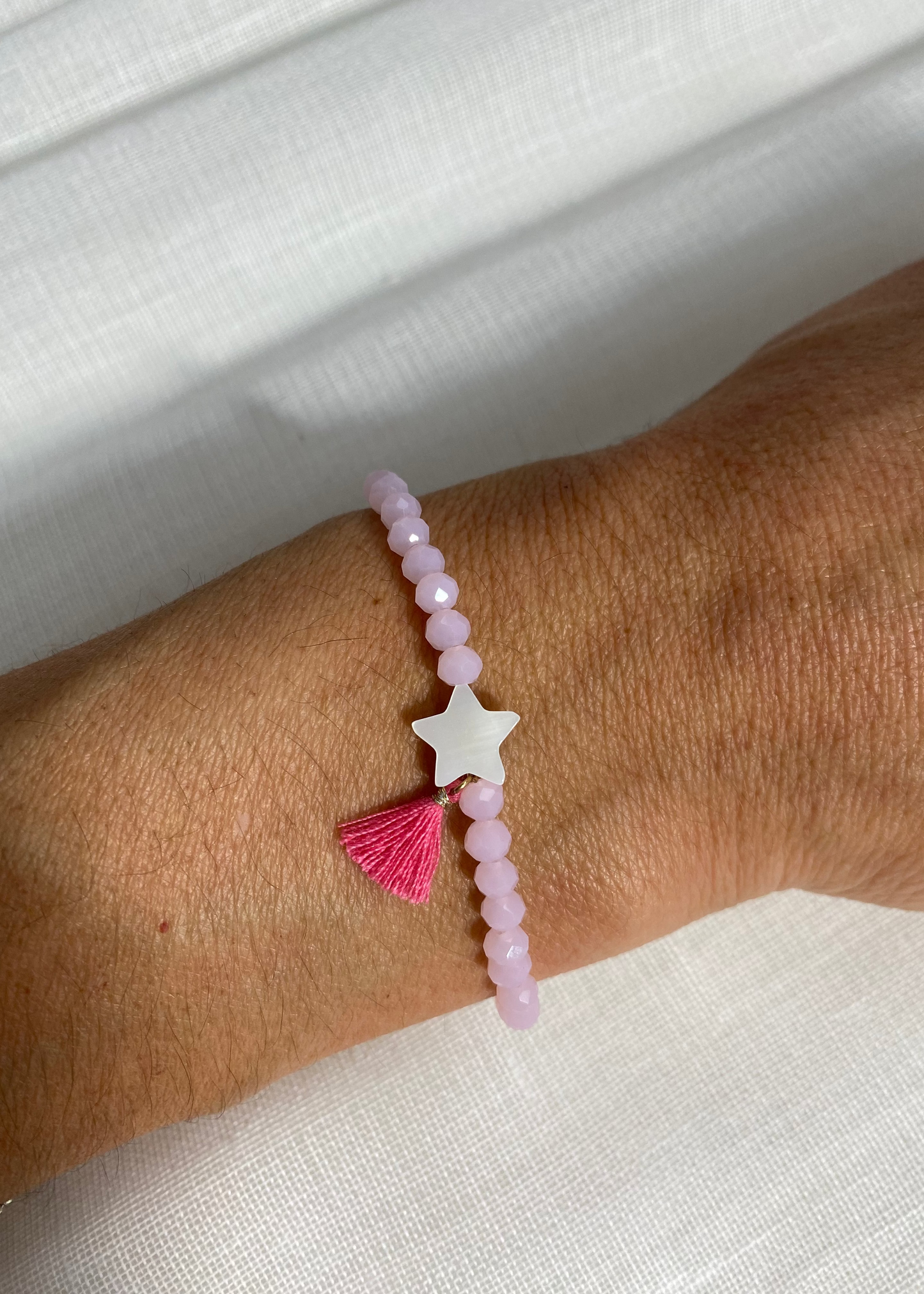 Pulsera estrella pompón